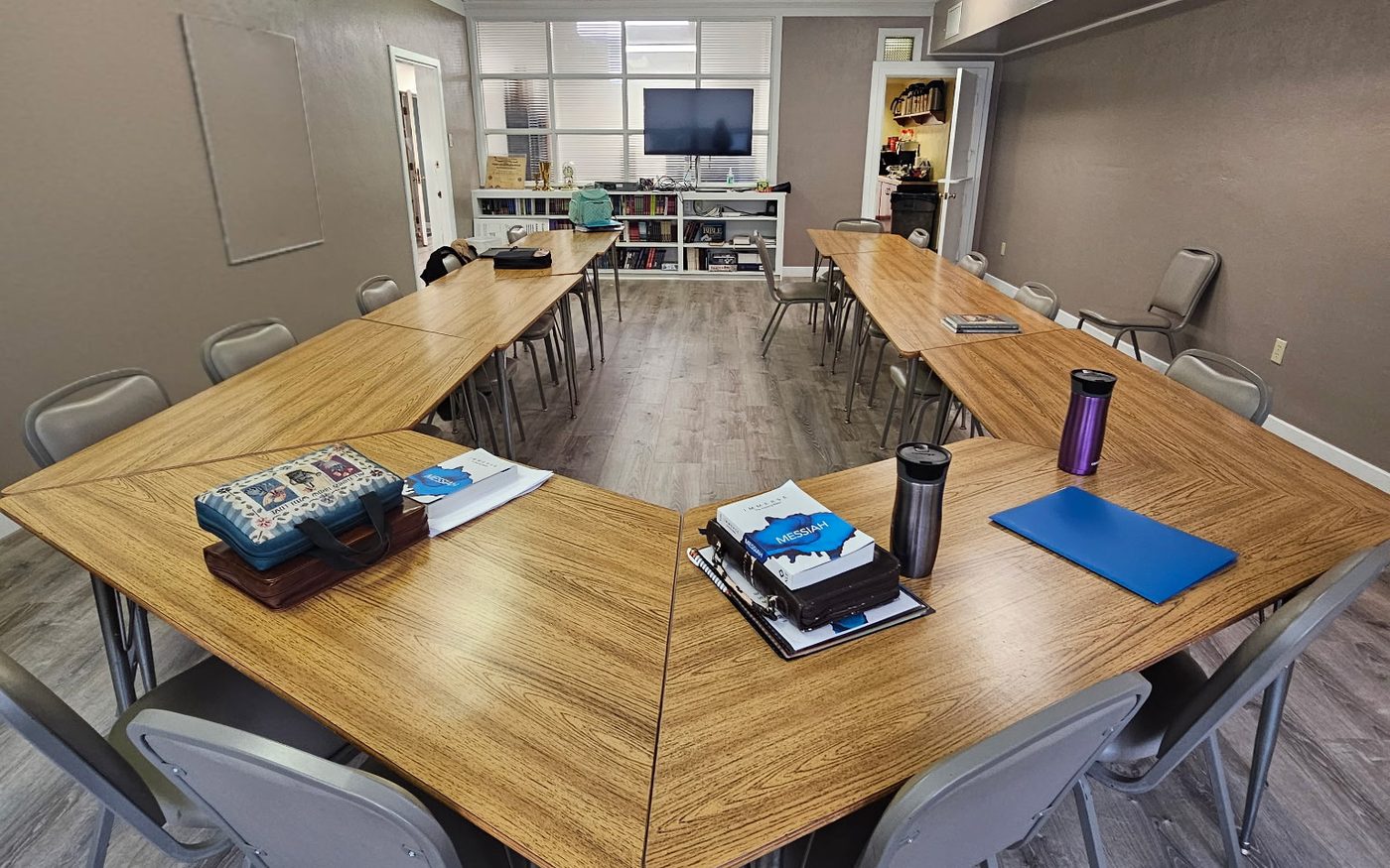 The Curriculum Room, with tables set in a U and chairs all around